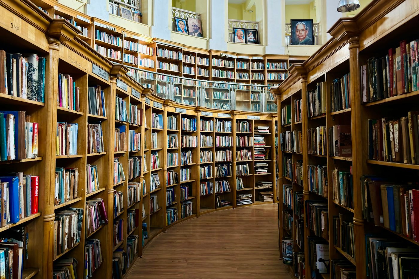 A long row of library shelves filled with books.