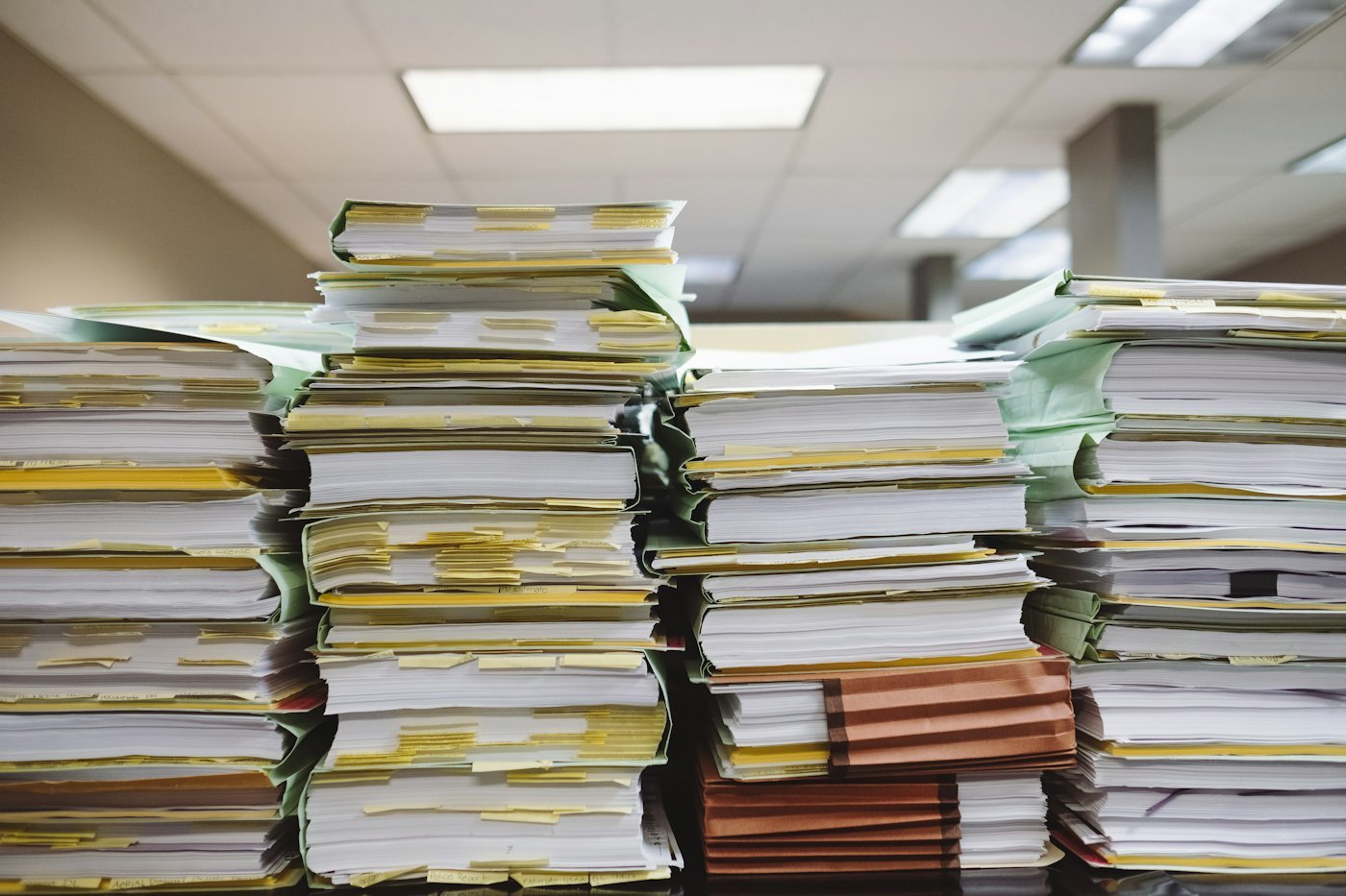 Stacks of paper documents and file folders.